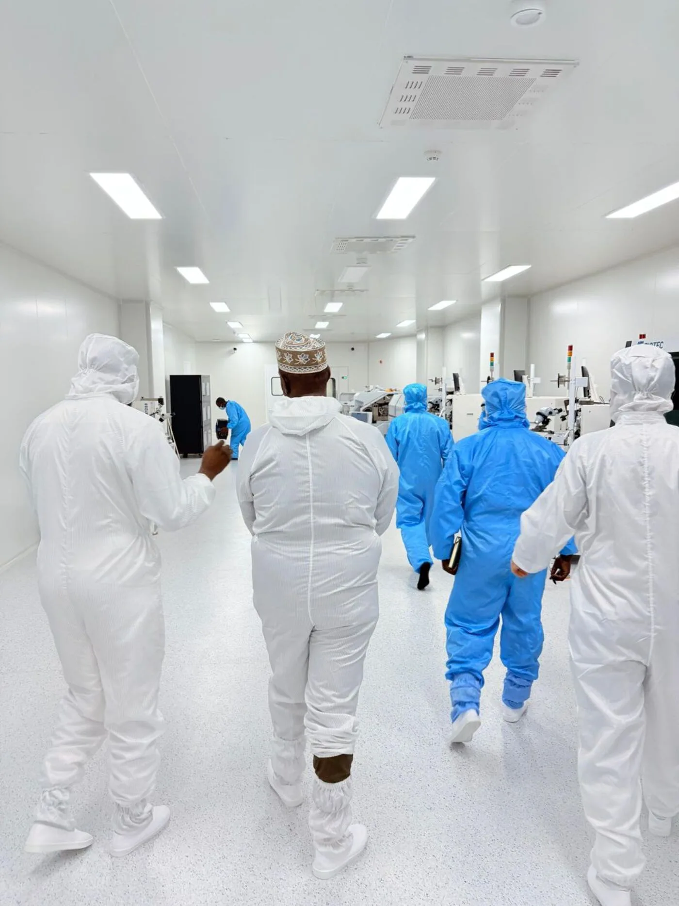 ASMC staff walking through the cleanroom production floor